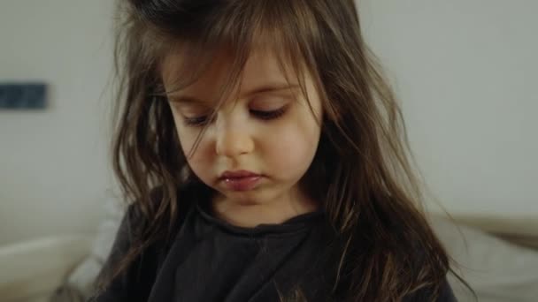 Toddler Layered Hair Bangs Sitting Bed Gazing Downward Her Nose — Stockvideo