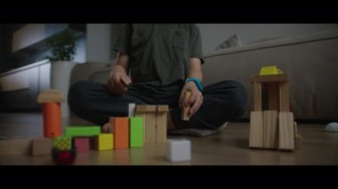 Tahta bloklarla oynayan bir çocuk ve bir adamın iç açıcı videosu, birlikte yapılar inşa ediyorlar. Yan yana yarattıklarında bağları ortaya çıkar.