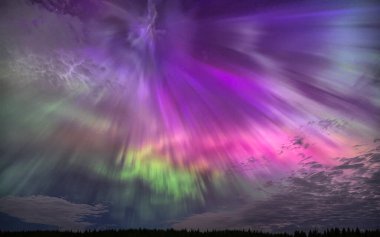 Colourful Northern Lights (Aurora Borealis) lighting up the sky on a beautiful spring night west of Ottawa, Canada