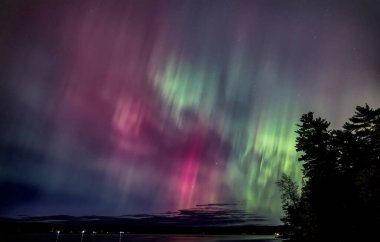 Northern Lights (Aurora Borealis) light up the sky on a beautiful cold autumn night along the Ottawa river near Ottawa, Canada Oct 10, 2024