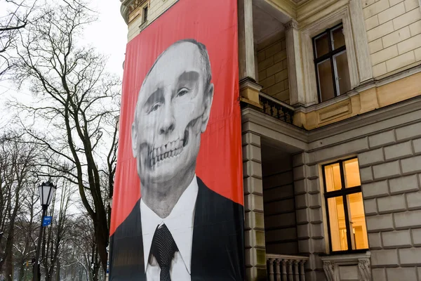 stock image RIGA, LATVIA. 24th February 2023.  Banner with painted Putin's skull