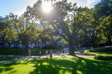 RIGA, LATVIA. 14 Ağustos 2022. Bastion Hill Parkı 'nda insanlar yürür. Riga şehir manzarası.