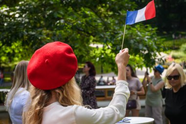 RIGA, LATVIA. 15th July 2024. A woman waves flag of France. The presentation of 