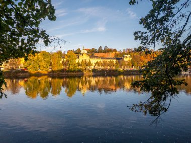 Picturesque autumn colors on the embankment by the Vltava river, Prague, Czech Republic