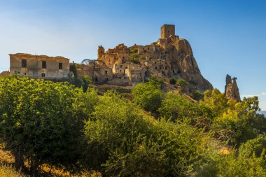 A picturesque view of the abandoned, old mountain town of Craco, built of sandstone rock. Craco is a ghost town abandoned due to an earthquake in the late 20th century. Province of Matera, Basilicata, Italy clipart