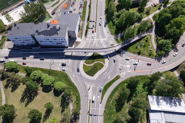 Aerial view of the street, roundabout, and pedestrian bridge over the crossroad in Finland