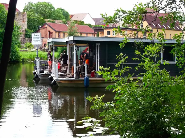 stock image City of Templin in the Uckermark, Brandenburg / Germany - June 17, 2024: With the bungalow boat from BUNBO in front of the city wall