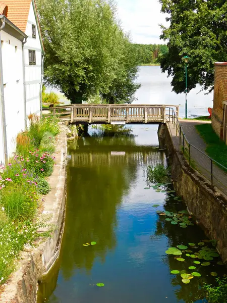 stock image The Mills Stream flows under a bridge into the Oberpfuhl Lake - inscription passage height 0.80 m