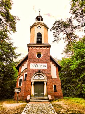 Historic chapel with inscription 120 years in the Uckermark clipart