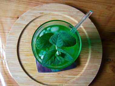 Refreshing drink with peppermint leaves in the hot season clipart