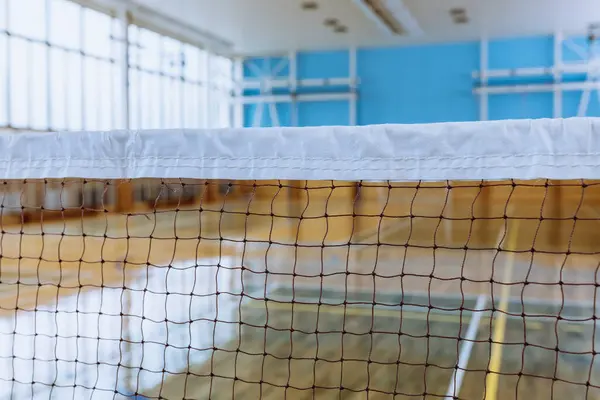 stock image Empty Indoor Sports Arena with Badminton Net, Highlighting Athletic and Recreational Spaces.