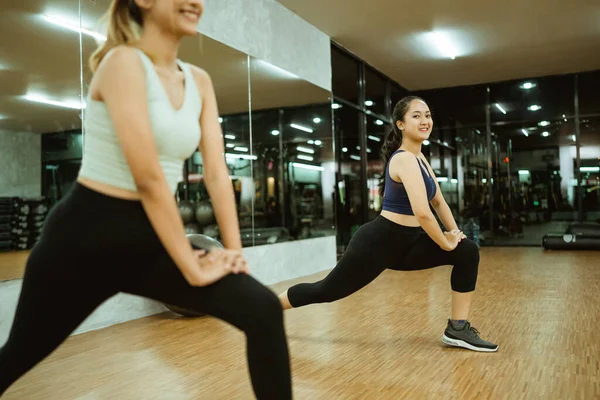 Close Two Girls Sportswear Stretching Thigh Muscles Gym —  Fotos de Stock