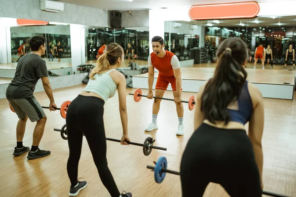 Group Young Sporty People Lifting Barbells While Bending Instructor Fitness — Stock Photo, Image