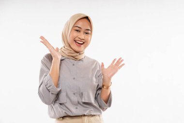 a beautiful woman with hijab standing with hands opened and smiling on the white background