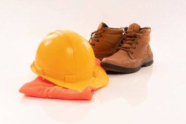 the equipment of architect include hardhat boots and safety waistcoat on isolated background
