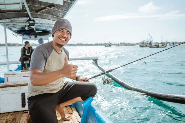Smiling Angler Thumbs While Holding Fishing Rod Small Fishing Boat — Stockfoto