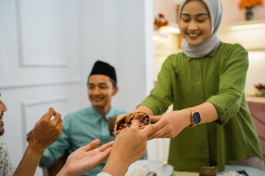dates are brought and served by the family to break the fast together at home