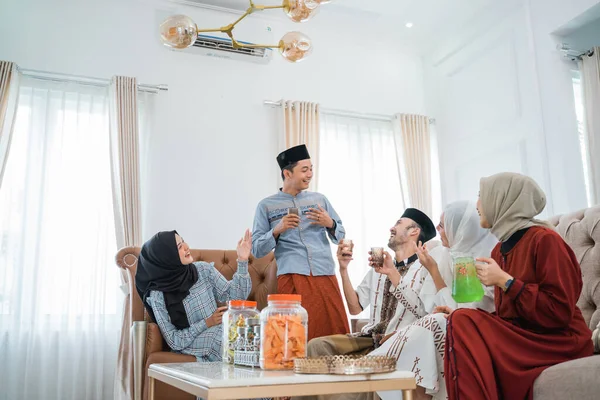 Muslim friends gather to eat snacks and drinks together to celebrate Eid at home