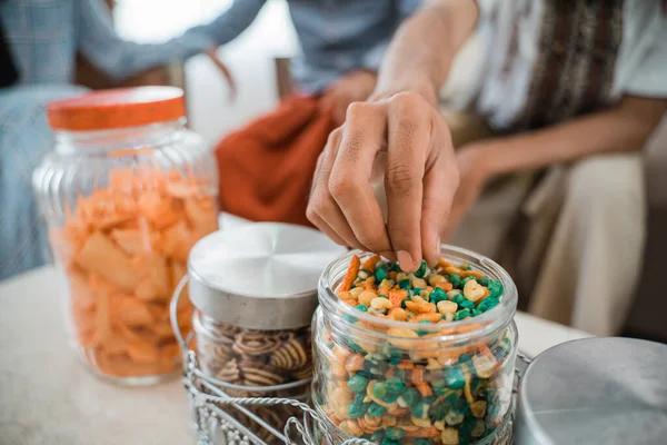 Mans Hand Takes Peanuts Glass Jar Full Snacks Table Living — Stock Photo, Image