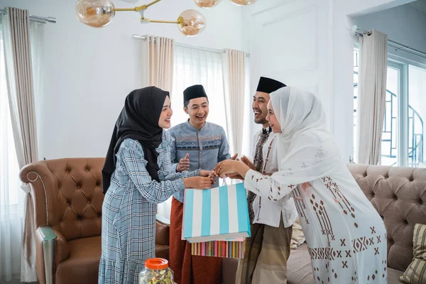 Muslims meet giving each other when celebrating Eid in the house when visiting
