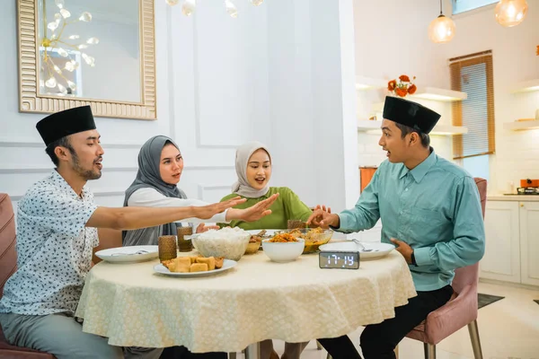 friends forbid a man from taking food before breaking the fast at the dining table