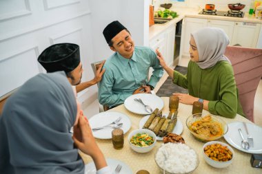 asian man stomach ache during fasting before breaking fast at home