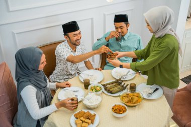 wife serves dates when breaking the fast together at home