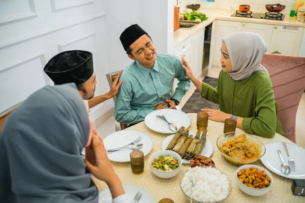 asian man stomach ache during fasting before breaking fast at home