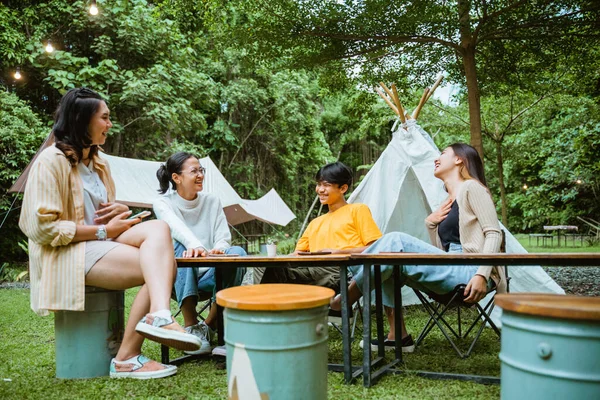 a group of people hangout and chatting together at camp site