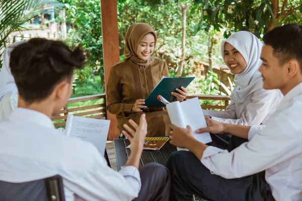 Teacher Looks Her Clipboard Students Discuss Doing Assignments Together Gazebo — Stock Photo, Image