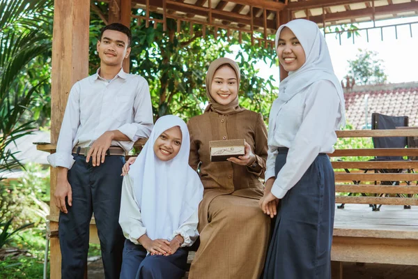 Elever Ler Mot Kameran Med Kvinnlig Lärare Medan Håller Hantverk — Stockfoto