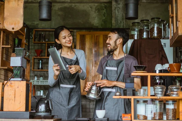 Female Barista Smiling While Pointing Digital Tablet Looking Laughing Male — Stock Photo, Image