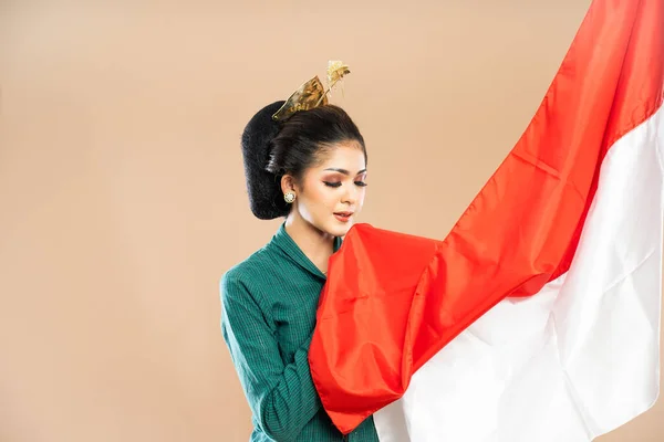 Yeşil Kebaya Giymiş Asyalı Bir Kadın Endonezya Bayrağını Alıp Yalıtılmış — Stok fotoğraf