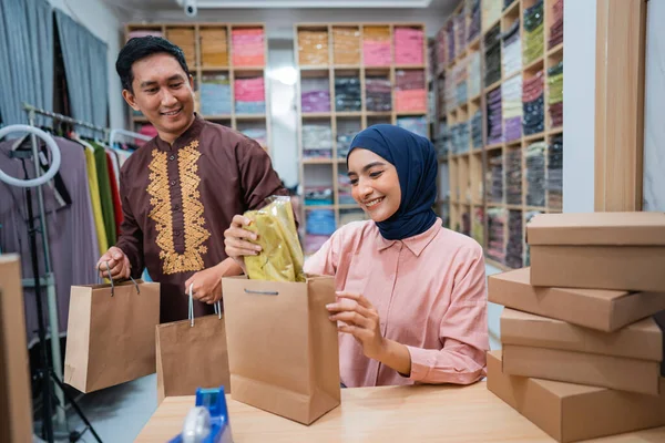 stock image two owner packing their product preparing for delivering package to customer