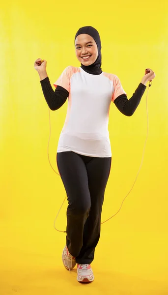 Sonriente Asiático Velado Mujer Usando Sportswear Usando Saltar Cuerda Amarillo —  Fotos de Stock