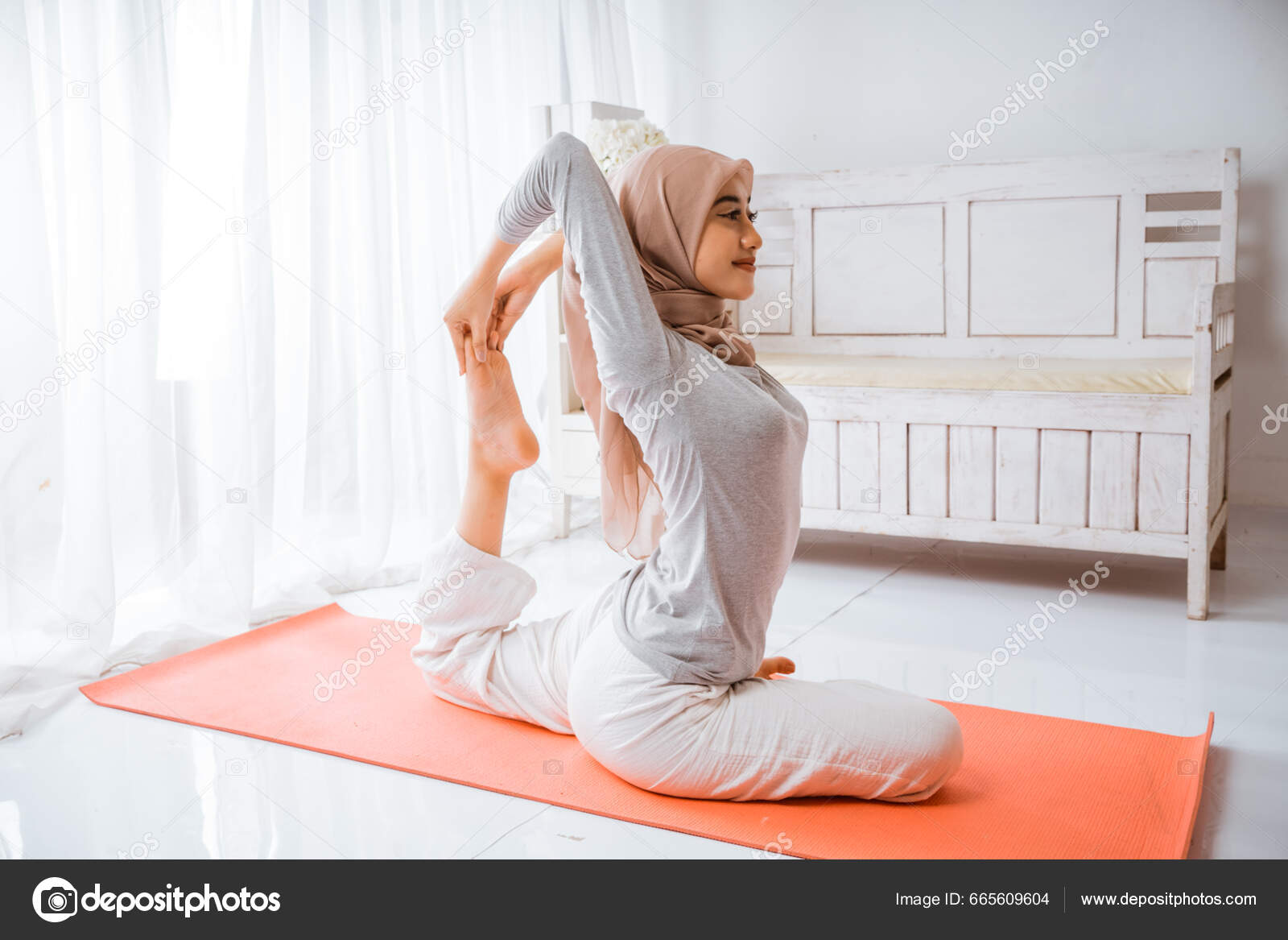 Asian Muslim Woman Instructor Wearing Hijab Doing Yoga Pilates Pose Stock Photo odua 665609604