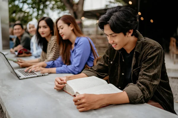 Asian Male University Student Reading Book Outdoor Coworking Space — Stock Photo, Image