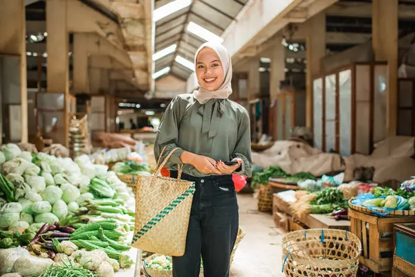 potrait of asian customer standing at farmer market looking for vegetables