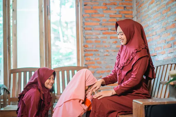 stock image Girls in beautiful traditional attire share joyful moments at home, creating cherished memories