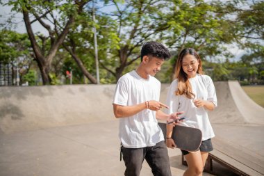 İki arkadaş açık havada kaykay parkında eğlenirken bağ kurar, birlikte eğlenirler.