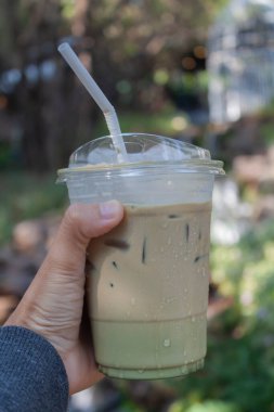 Woman hold her iced coffee, stock photo