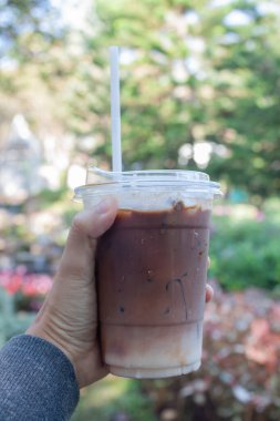 Woman hold her iced coffee, stock photo