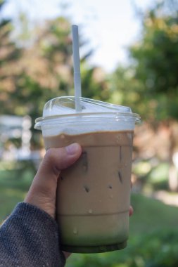 Woman hold her iced coffee, stock photo