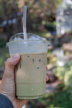 Woman hold her iced coffee, stock photo