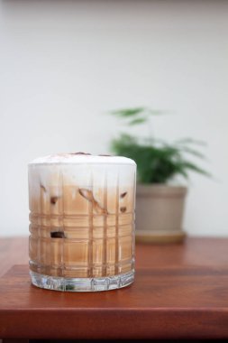 Iced coffee with micro foam in coffee shop, stock photo