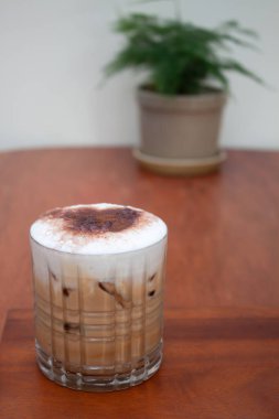 Iced coffee with micro foam in coffee shop, stock photo