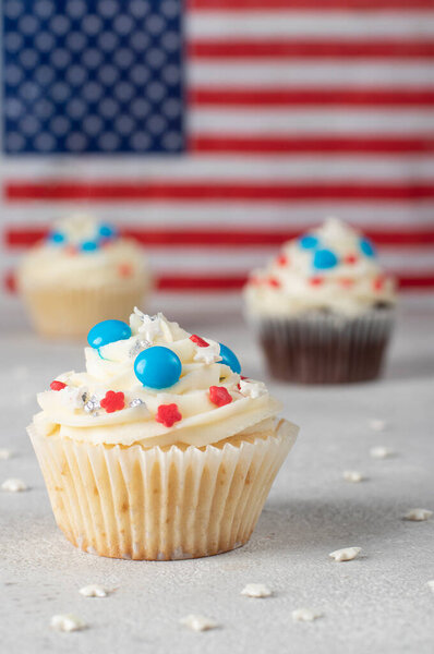 Patriotic cupcakes for USA Independence Day on the background of the American flag, Happy Memorial Day 4th of july