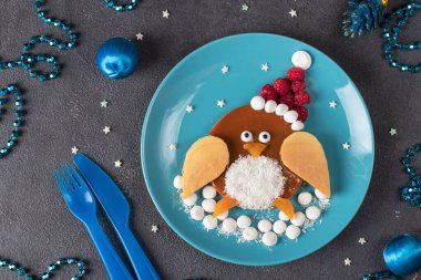 Penguin form pancake with raspberry for breakfast - fun food idea for kids