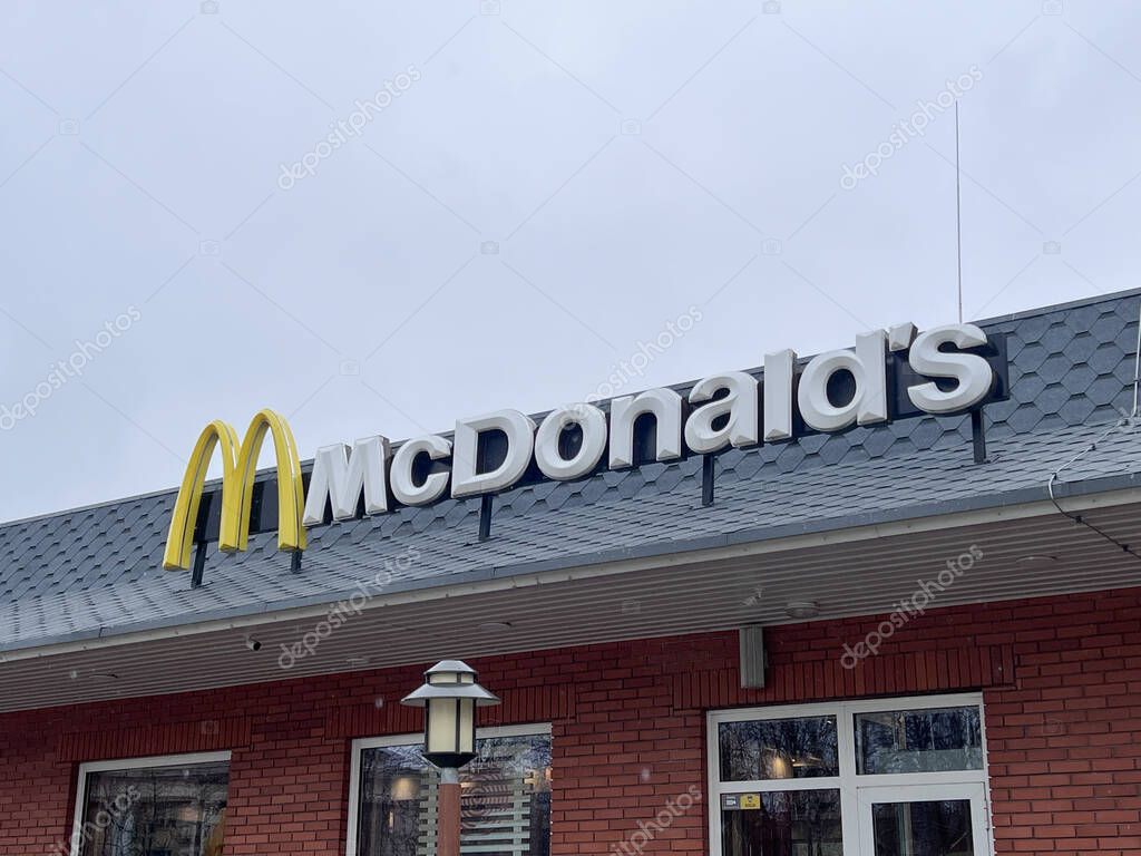 McDonalds burger fast food restaurant. The famous McDonalds logo with golden arches on the roof of the building, Kremenchug, Ukraine, 31.03.2025