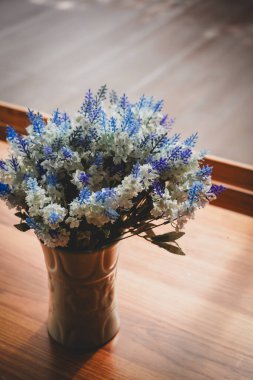 the flower on the wooden table with dramatic tone clipart